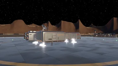A silver box-section cargo ship with a dish antenna on its roof fires white lift jets from a landing pad, brown mountains behind it.